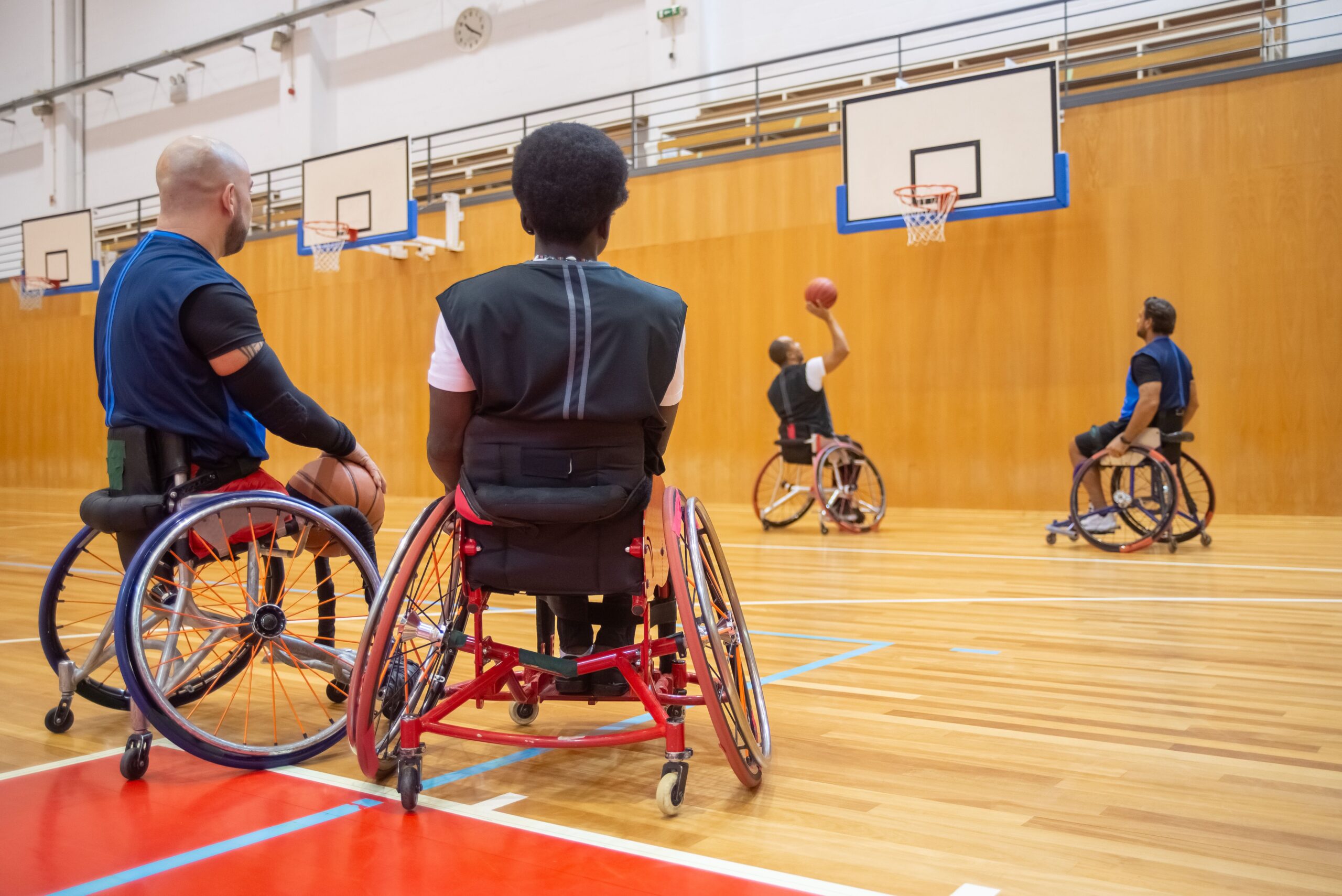 People playing wheelchair basketball in an indoor sports hall